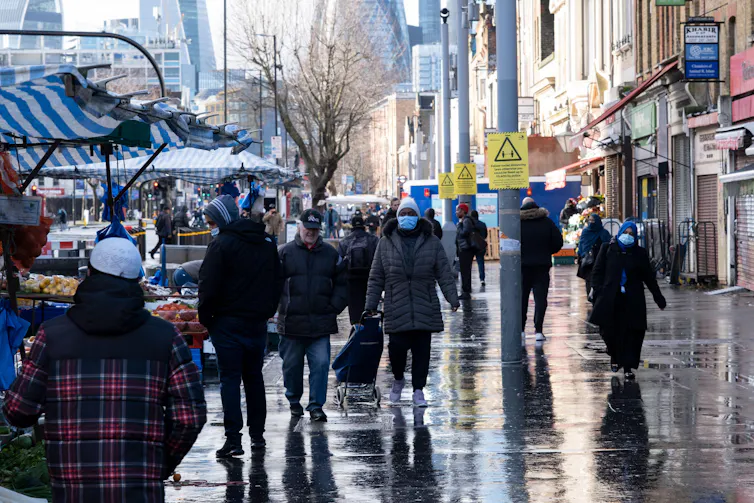 People wearing masks, Whitechapel High Street, London.