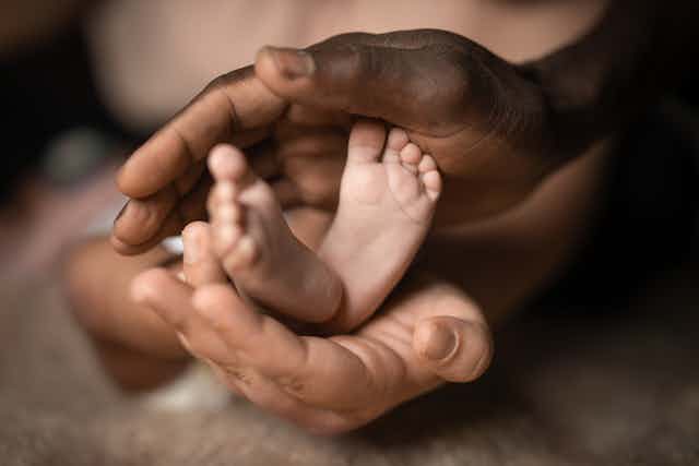 Hands holding a baby's feet 