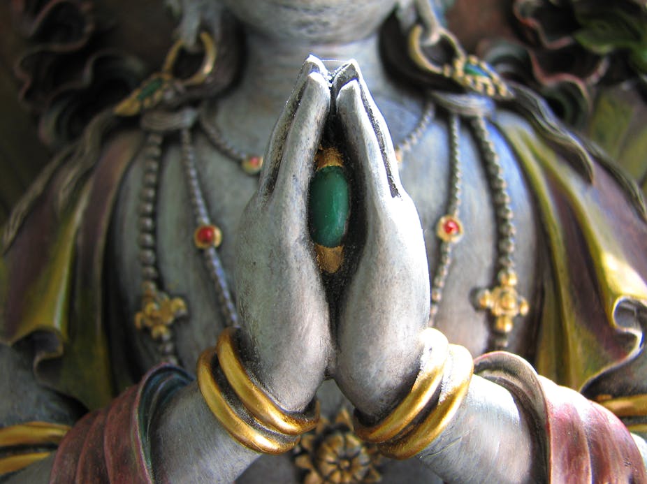 Avalokiteshvara, the bodhisattva of compassion, holding a jewel between his folded hands.
