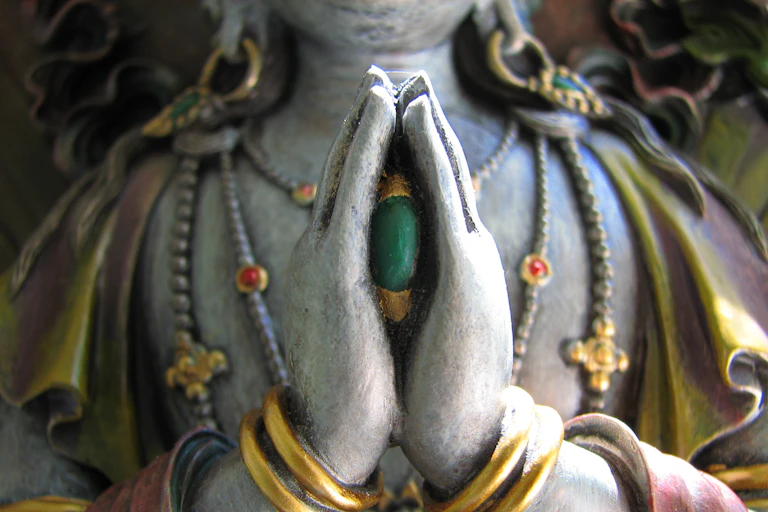 Avalokiteshvara, the bodhisattva of compassion, holding a jewel between his folded hands.