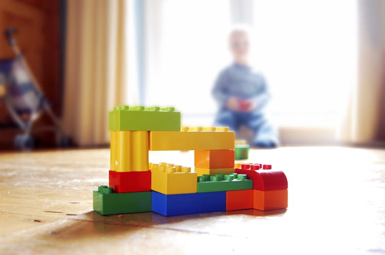 A child looks at building block toys.