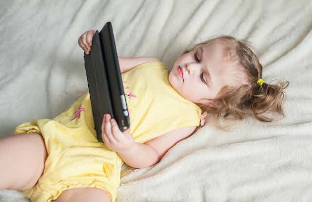 Young child watching something on a digital device