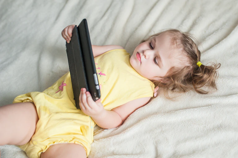 Young child watching something on a digital device