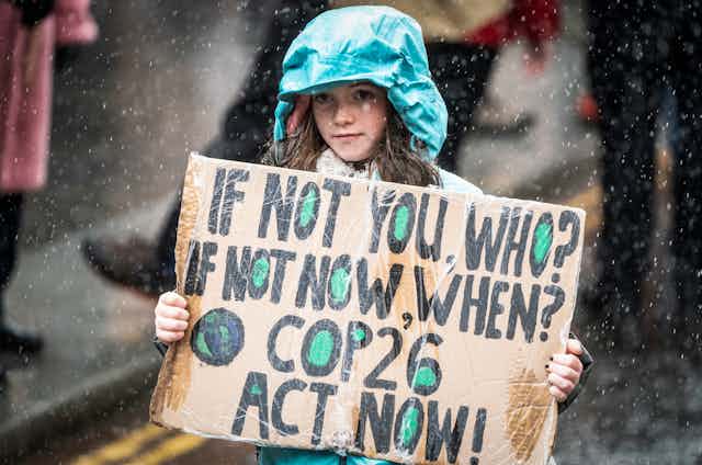 Child holding up sign at climate change protest