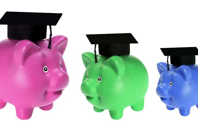 Three different-coloured piggybanks with mortar boards on top