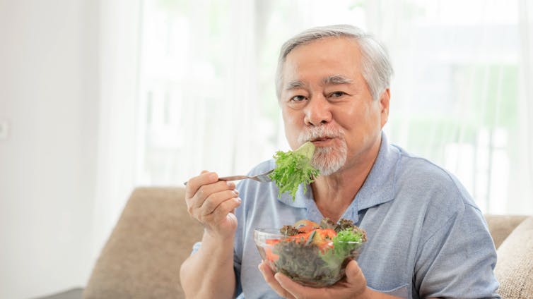 Old man eats salad