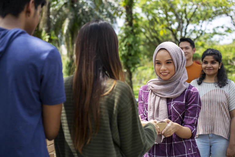 A Muslim woman giving donations.