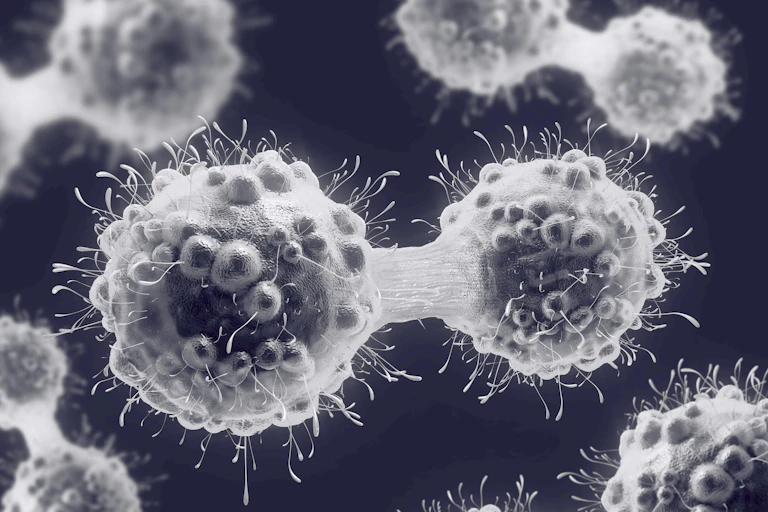 Illustration of cancer cells dividing.