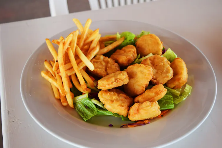 A plate of chicken nuggets and fries