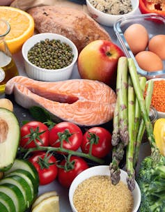 Foods typical of Mediterranean style diet, including fish, grains, fruits, vegetables and beans