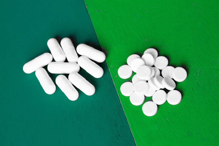Two different shaped white pills