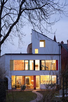 A modern house with wall-length windows.