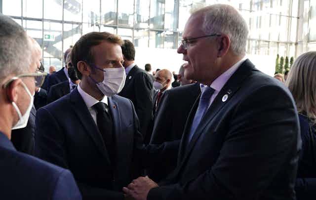 Scott Morrison greets Emmanuel Macron at the G20.