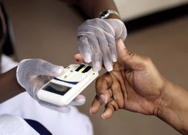 A mans finger is pricked to test his cholesterol at the City of Newark's free homeless health fair at the Department of Child and Family Well-Being on August 13, 2009 in Newark, New Jersey