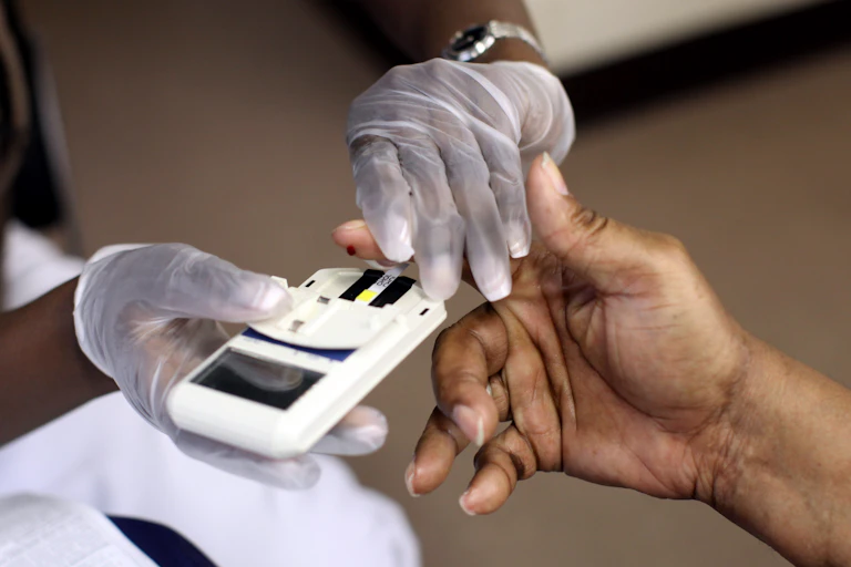 A mans finger is pricked to test his cholesterol at the City of Newark's free homeless health fair at the Department of Child and Family Well-Being on August 13, 2009 in Newark, New Jersey