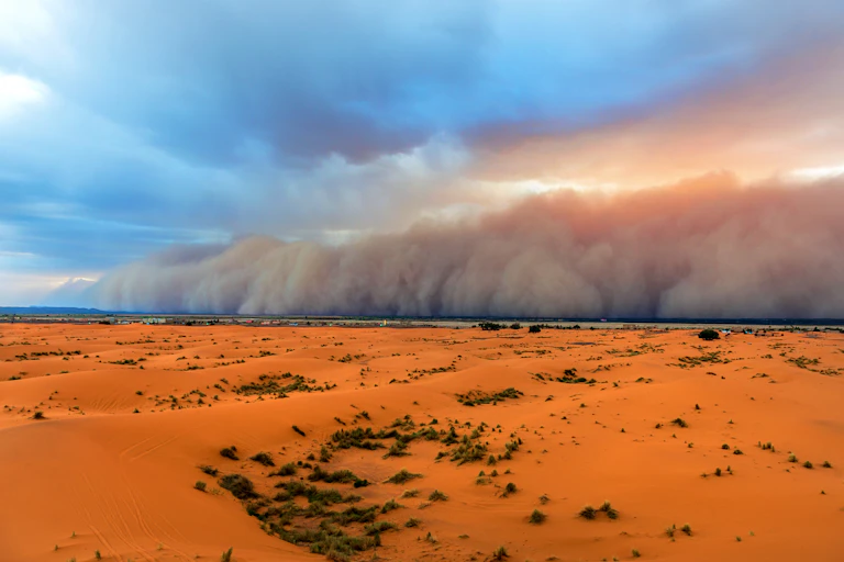 Sandstorm meeting clouds, sky and desert.