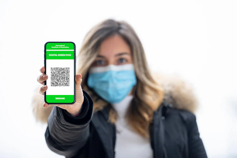 Woman showing her 'green pass' on her phone.