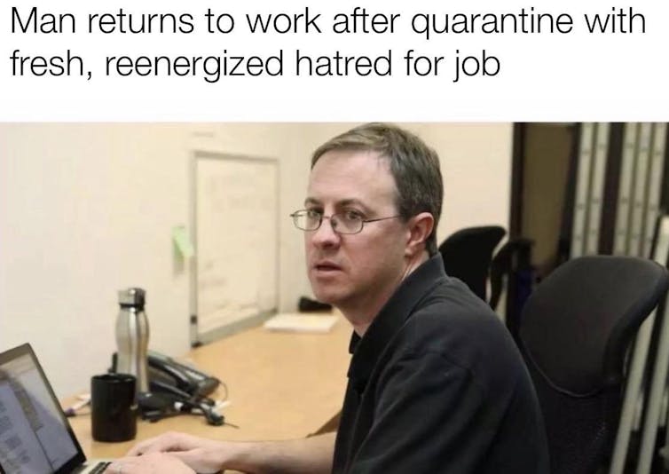 A photo of a man looking sad at his desk