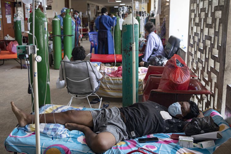 A hospital ward in Iquitos, Peru, with patients being given oxygen directly from cyclinders