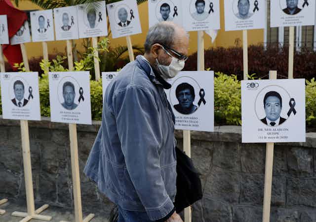 A display of photos of Peruvian doctors who died of COVID