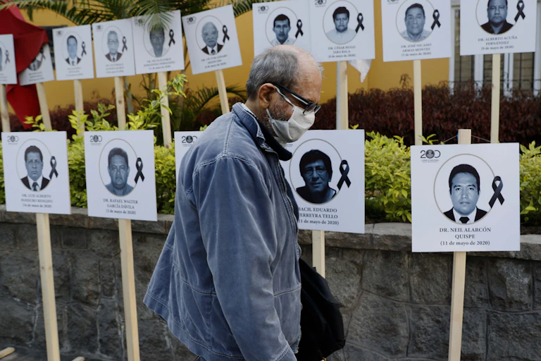 A display of photos of Peruvian doctors who died of COVID
