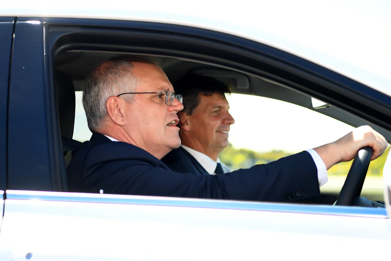 two men in front seats of vehicle
