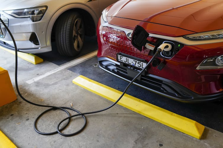 electric vehicle being charged in parking lot