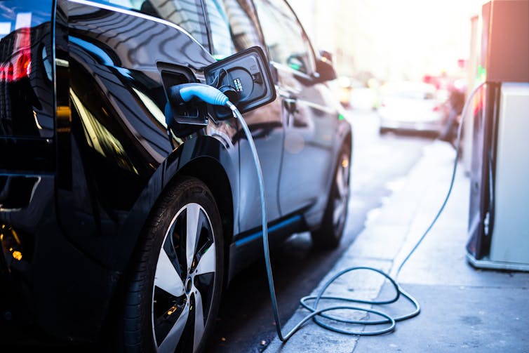 Electric car plugged in to charger.