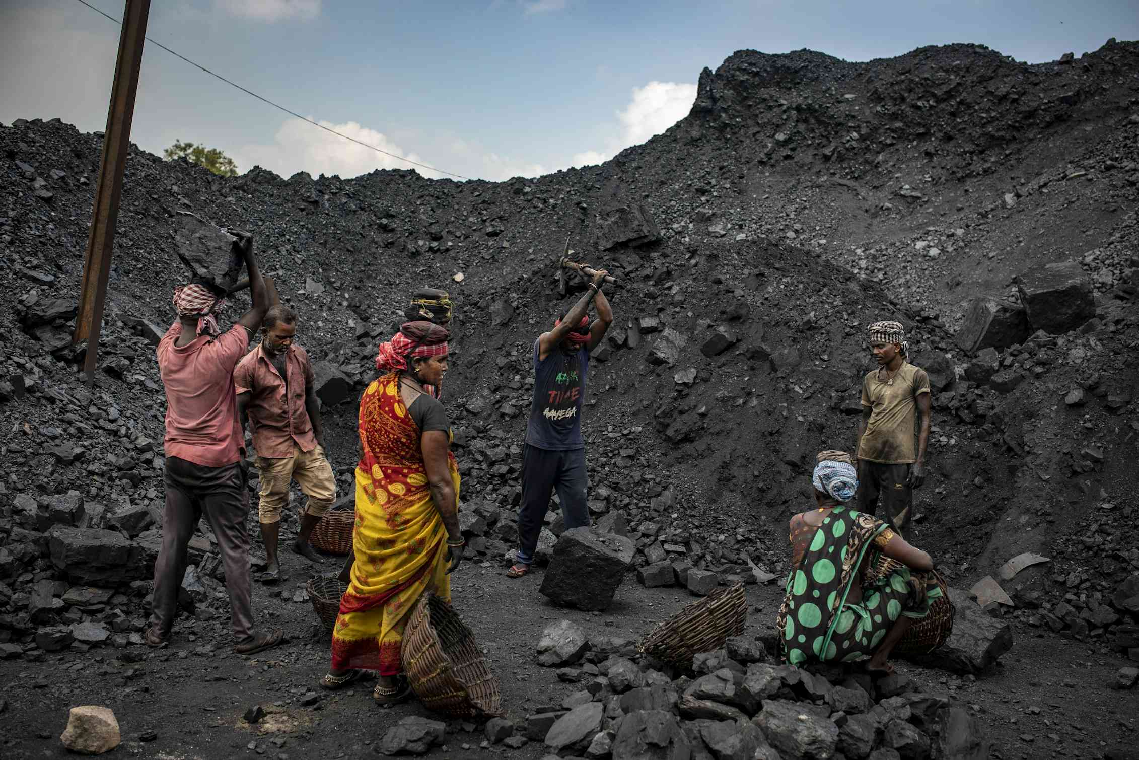 people dig in coal pile