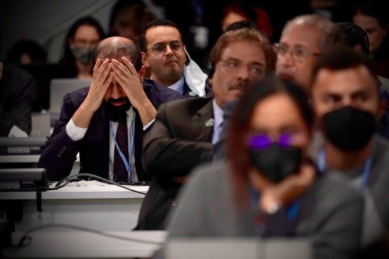 man puts head in hands