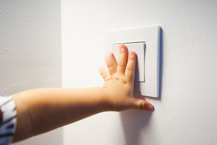 Child using light switch