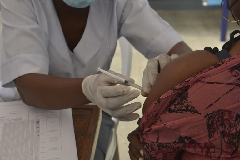 A medic administers a dose of the Moderna Covid-19 corononavirus at the Oregun Primary Health Care Center in Ikeja capital of Lagos on 25 August, 2021.