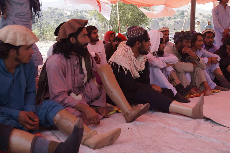 Afghani men with prosthetic limbs from injuries caused by landmines, Pakistan, September 2021