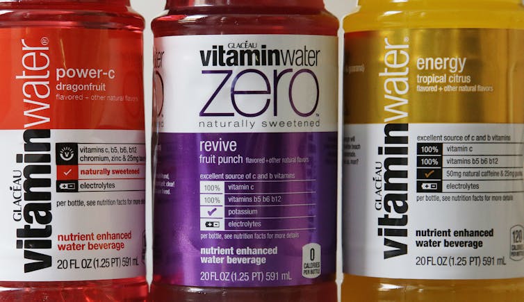 A closeup of three Vitamin Water labels showing health claims.