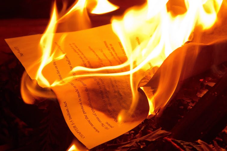 A copy of the Indian Act is burning.