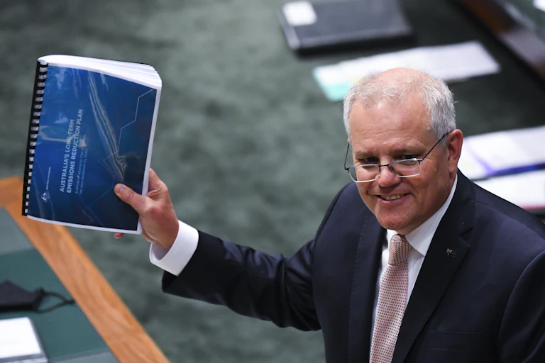 Scott Morisson holds the blue emissions reduction plan
