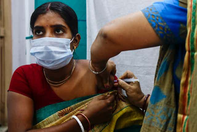 Indian woman getting vaccine. 