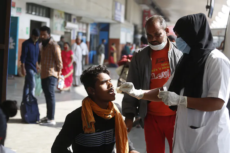 Indian man receiving COVID test.