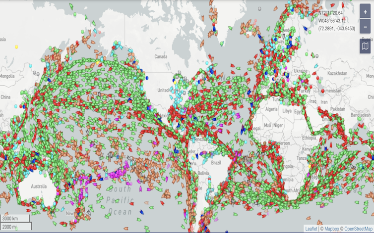 Shot of live map of shipping traffic, with cargo vessels in green.