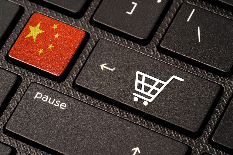 Keyboard with keys showing shopping trolley icon and Chinese flag.