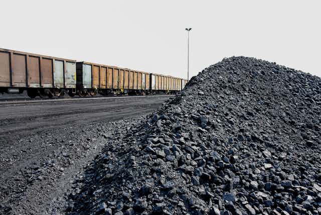 Piles of processed coal next to a rail siding.