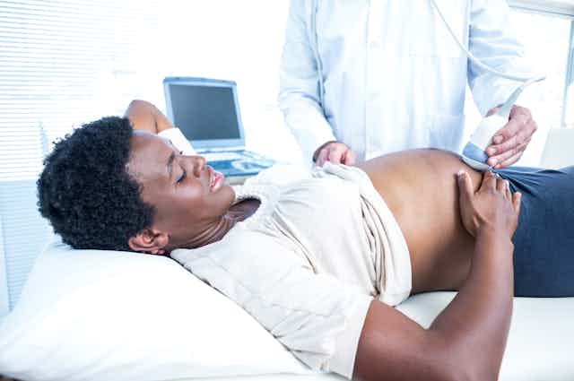 Pregnant Black woman having ultrasound