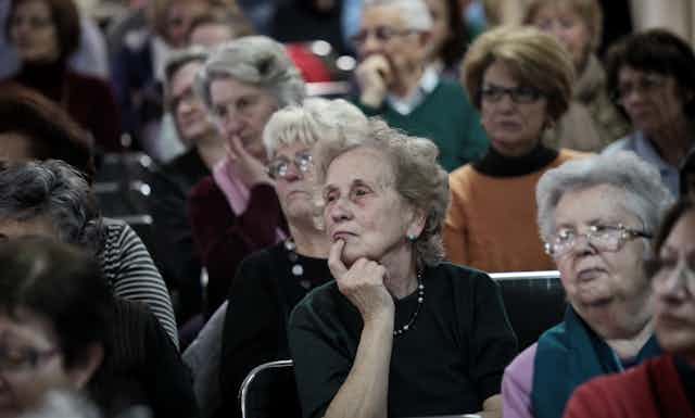 An auditorium filled with older people.
