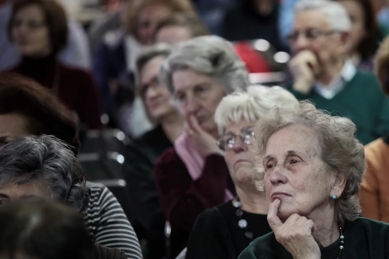 An auditorium filled with older people.