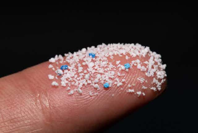 Microplastic pellets on a finger