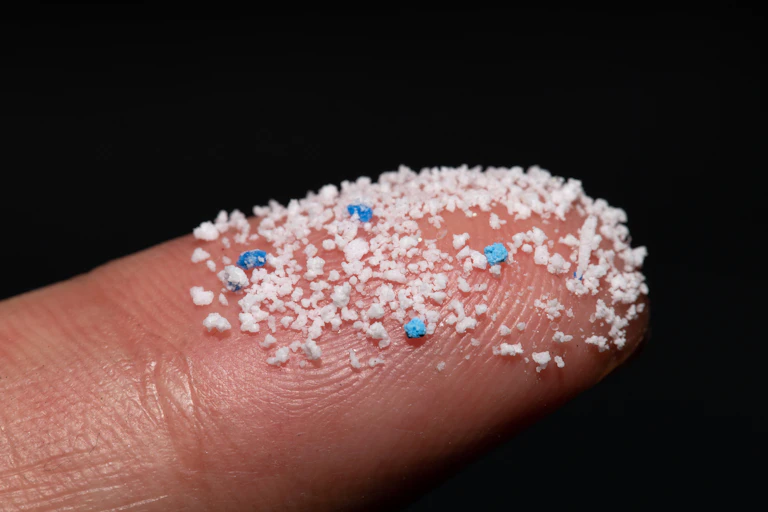 Microplastic pellets on a finger