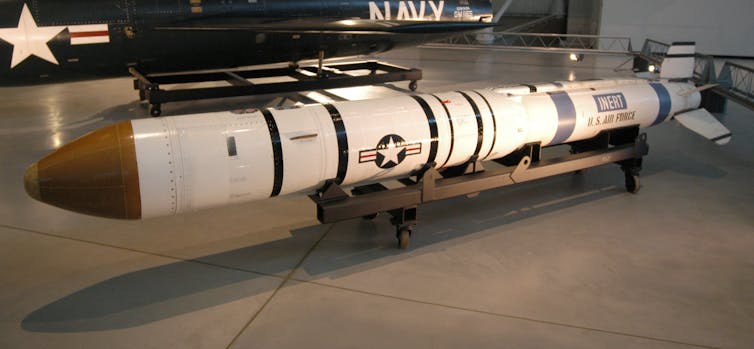 A long white and red missile on display.