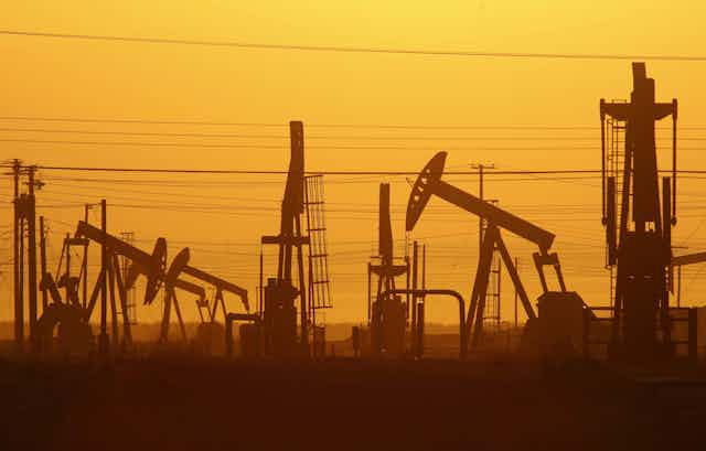 Pump jacks at an oil field, photographed at dawn.