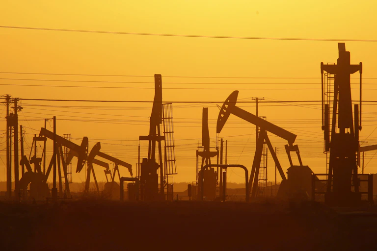 Pump jacks at an oil field, photographed at dawn.