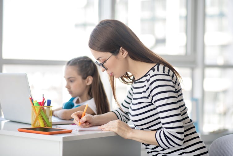 Mother and daughter sitting at a table as they study